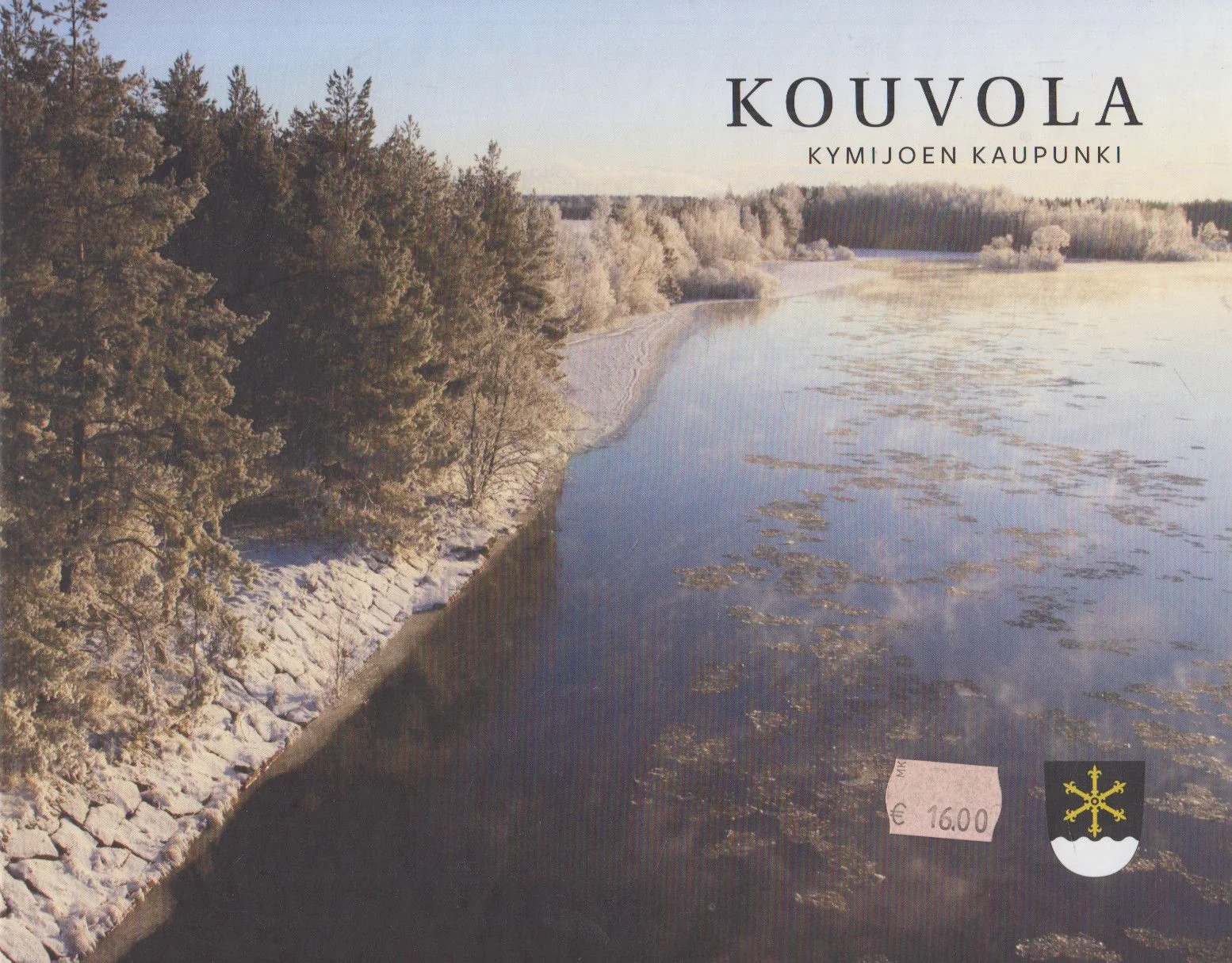 Обложка книги «Kouvola : Kymijoen kaupunki = Kouvola : staden vid Kymi älv = Kouvola : the city by Kymi River = Kouvola : die Stadt an dem Fluss Kymijoki = Kouvola : gorod na reke Kûmi»